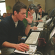 Russians peer into computer screens at an Internet cafe in Moscow, Russia Monday, Feb. 21, 2000.